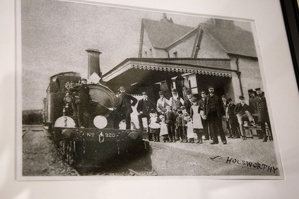 Early photo of steam train and workers at Holsworthy station
