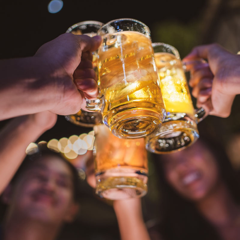 Friends raising a toast with pints of beer